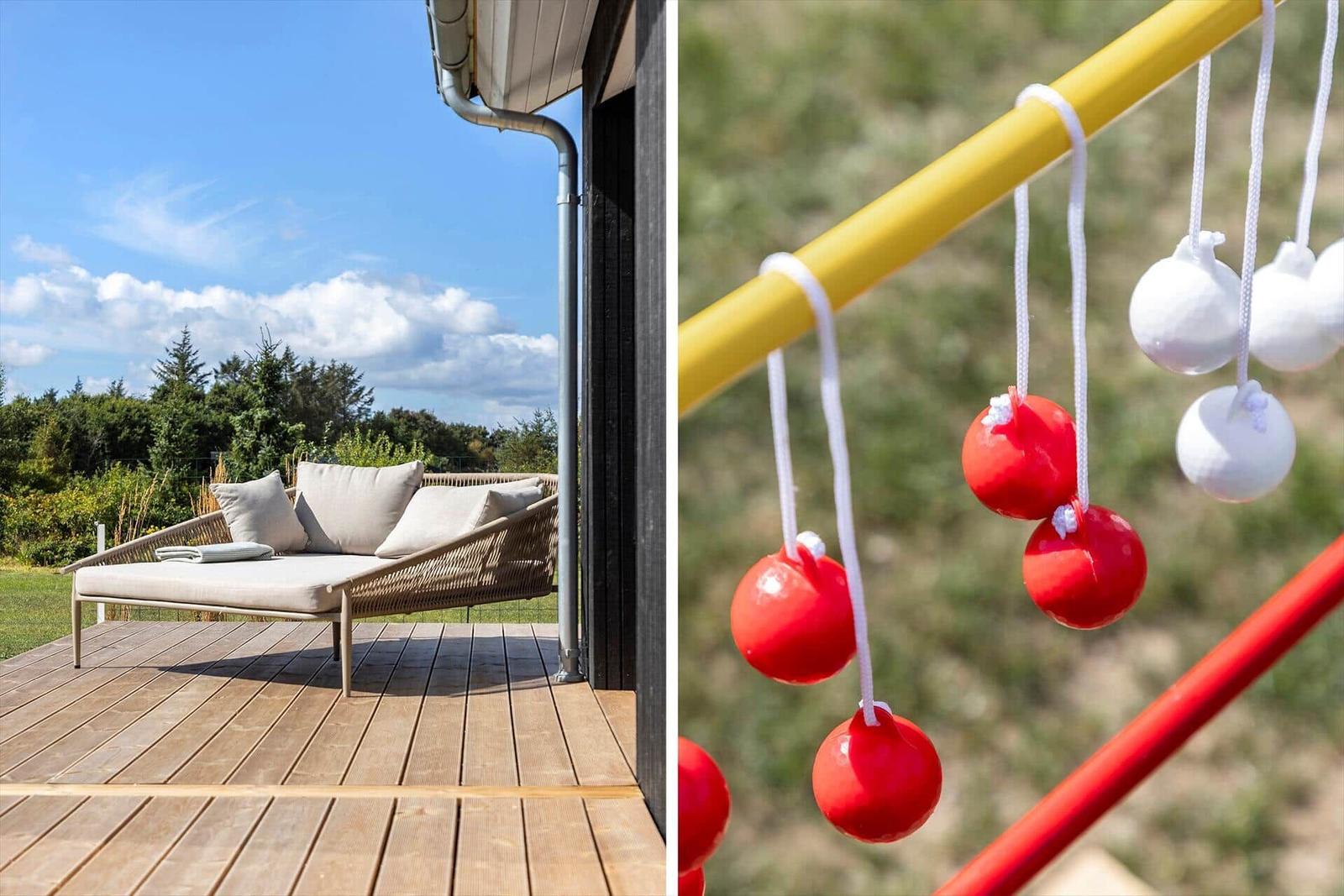 Terrasse mit Liegestuhl und Blick auf Wiese und Bäume. Spielgerüst mit roten und weißen Kugeln.