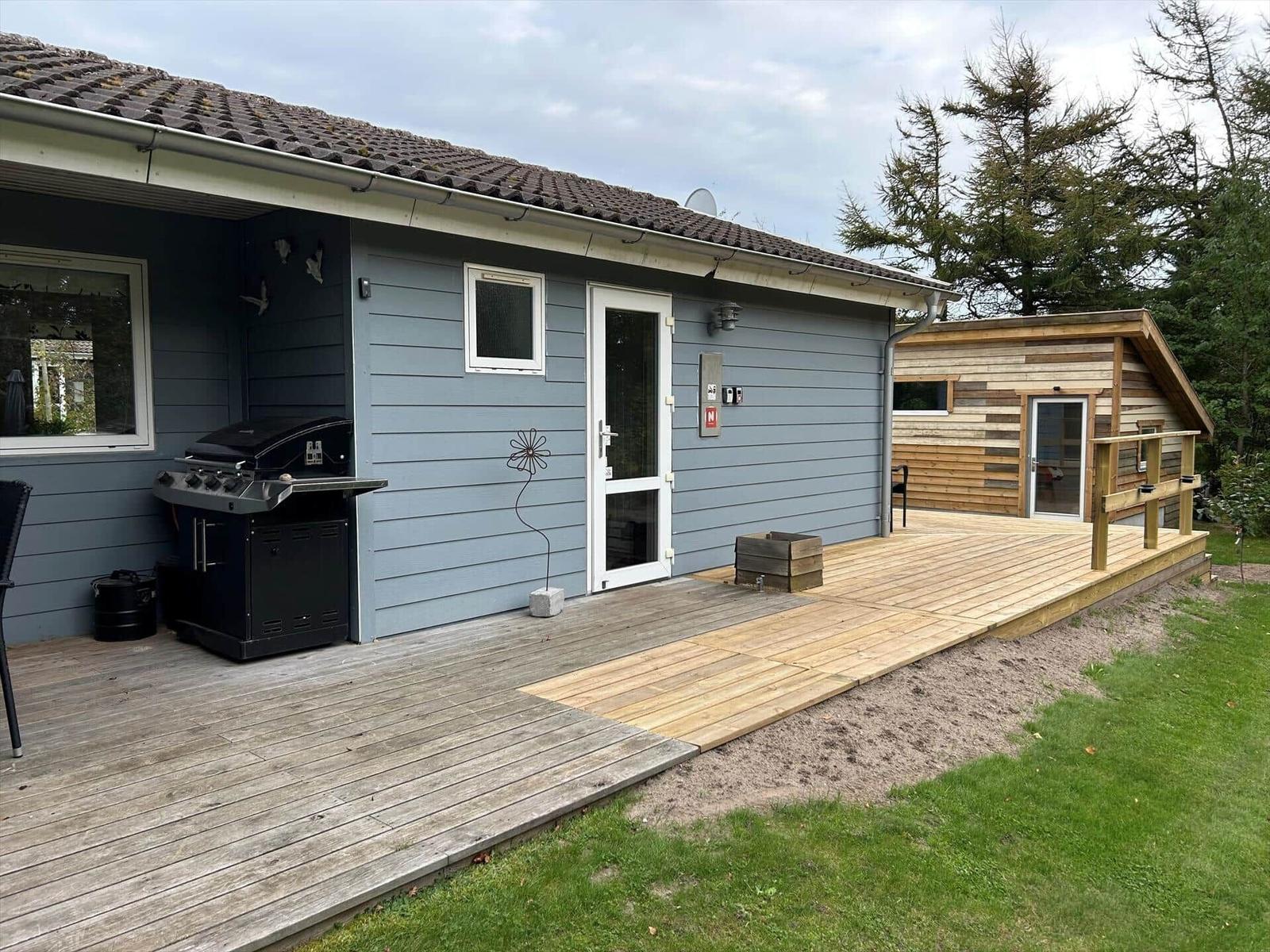 House with wooden terrace, grill and garden. Adjacent wooden house.