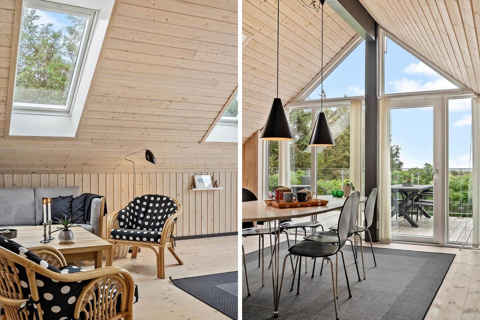 Wohn- und Essbereich mit Holzwänden, großen Fenstern und Terrasse.