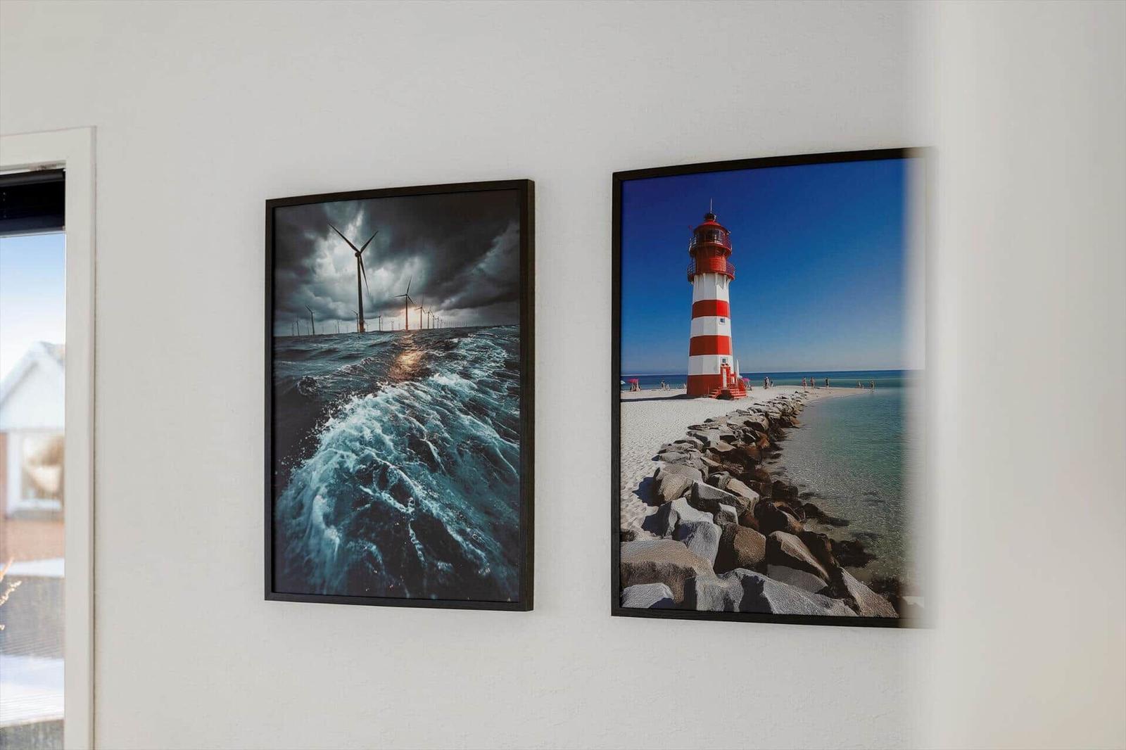 Two wall pictures show wind turbines and a lighthouse on the coast.