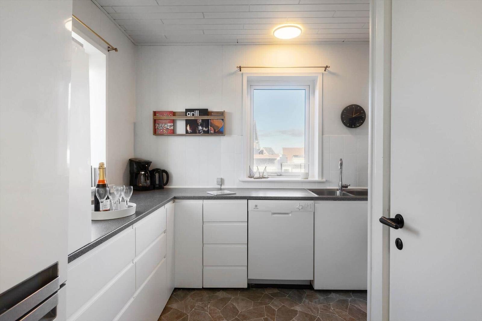 Kitchen with worktop, sink, dishwasher, and window with view.