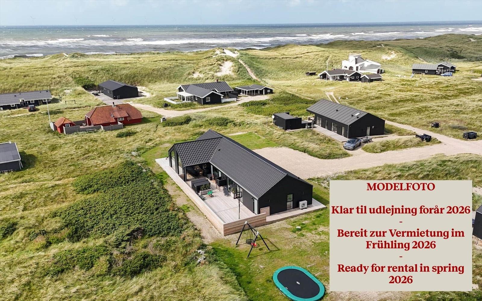 Moderne Ferienhaus mit Terrasse und Trampolin auf Dünenlandschaft. Bereit zur Vermietung im Frühling 2026.