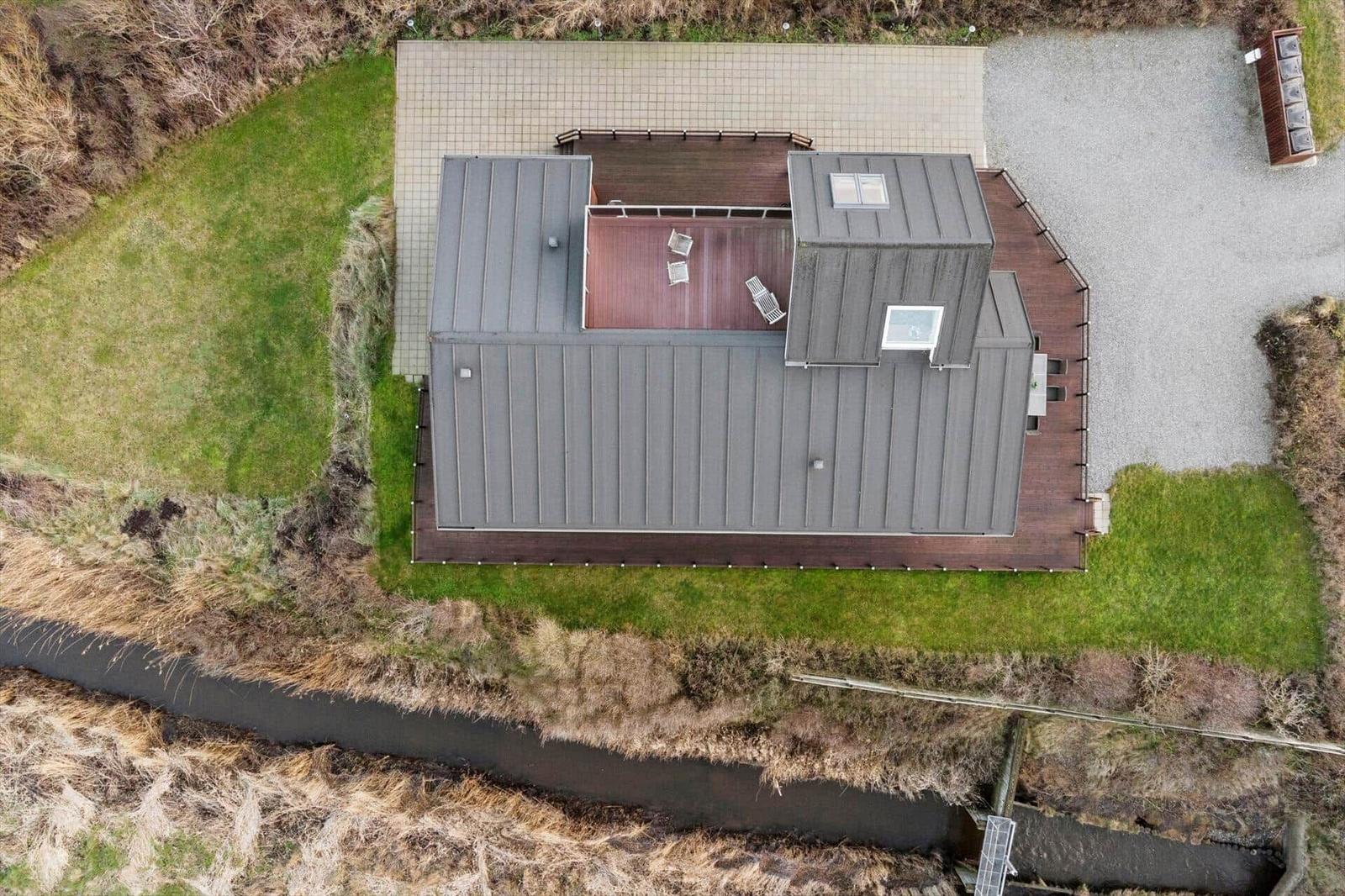 Modern cabin with terrace, garden, and riverfront location.