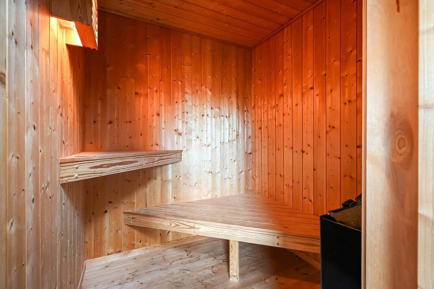 Sauna with wooden walls and benches.