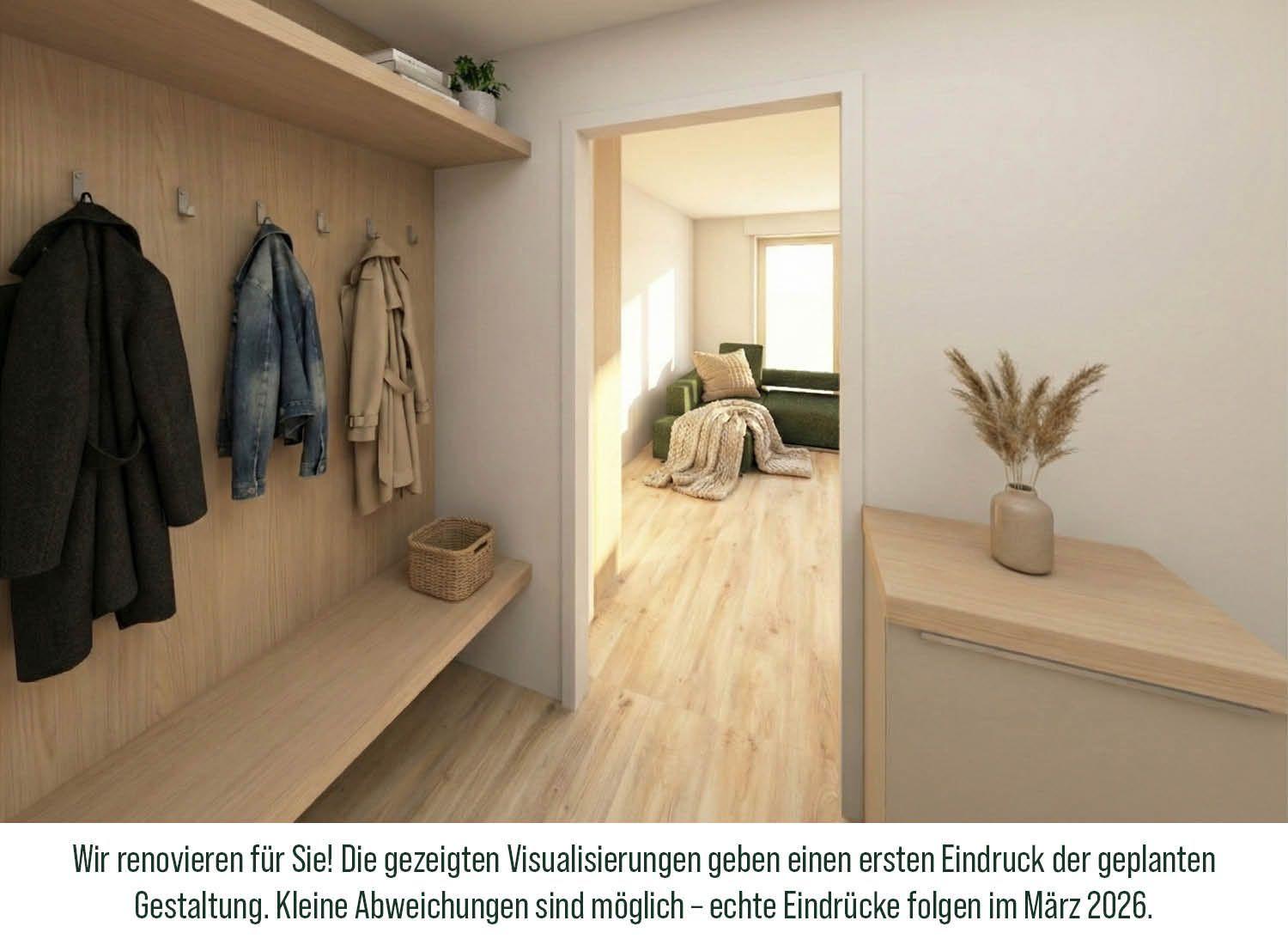 Eingangsbereich mit Garderobe, Sitzbank und Blick in Wohnzimmer mit Sofa und Fenster.