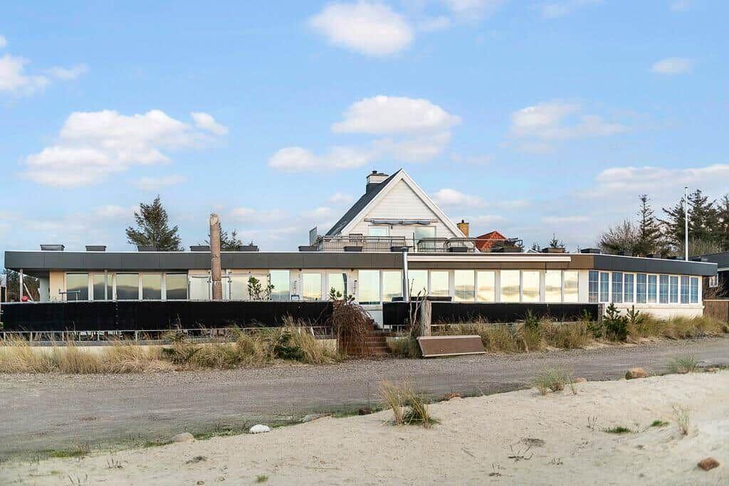 Modern house with large glass area and terrace by the beach