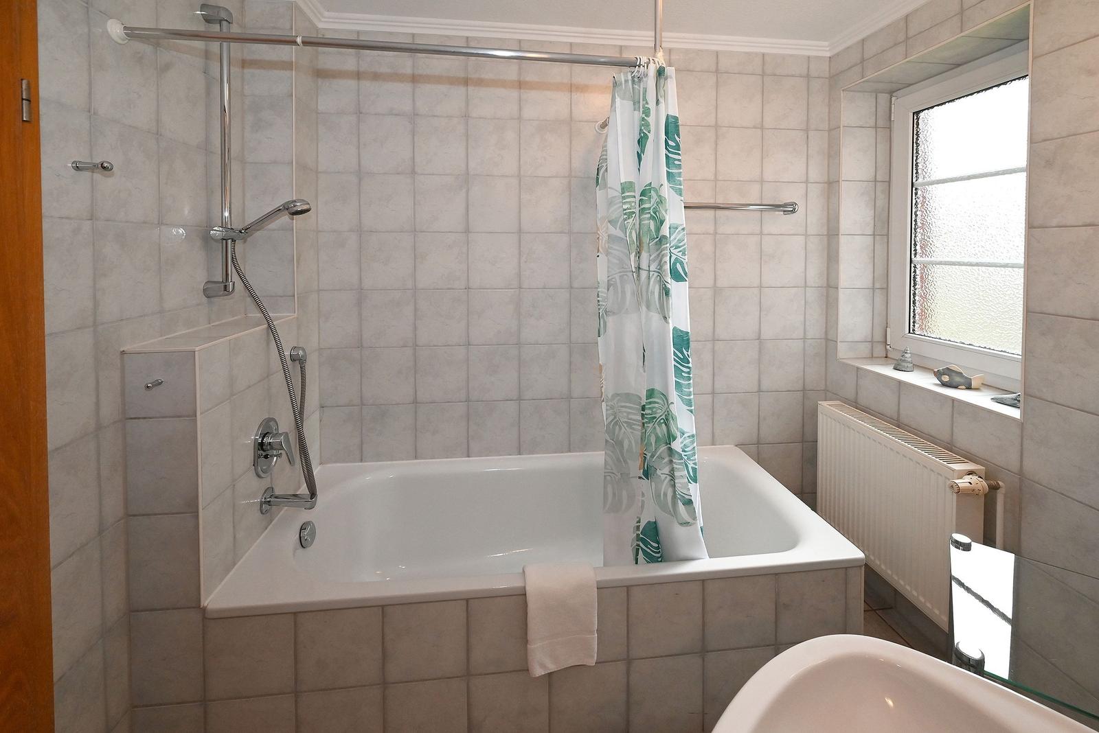 Bad mit Badewanne, Duschbrause und Fenster