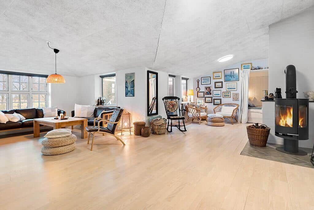 Living room with fireplace, sofa, chairs, and wall decor.