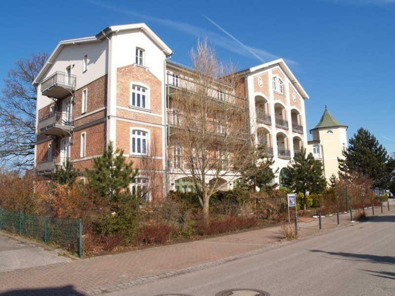 Haus mit Balkonen und Ziegelfassade an sonnigem Tag