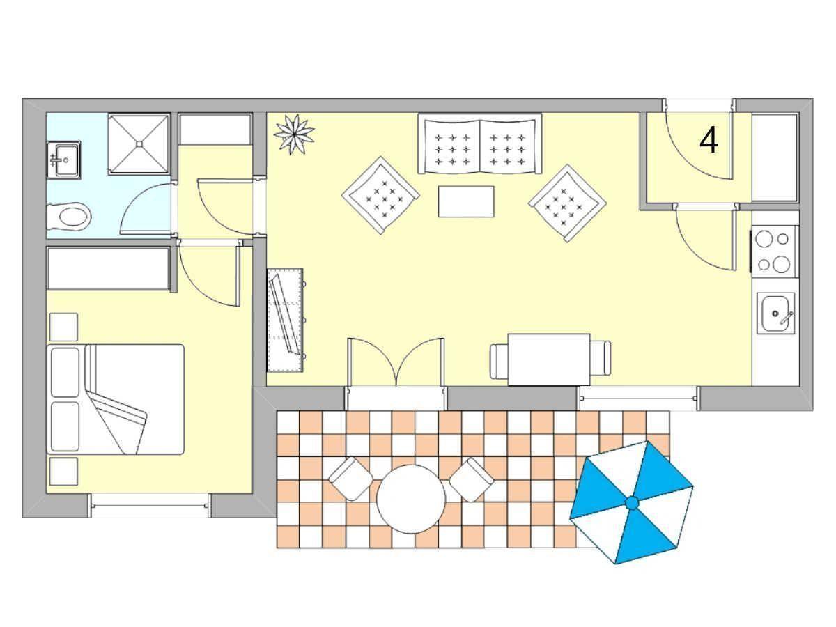 Ein Wohn- und Schlafzimmer mit Küche, Bad und Terrasse mit Tisch und Sonnenschirm.