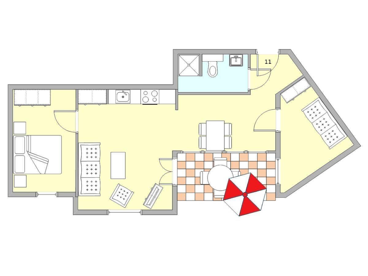 Wohnung mit Küche, Schlafzimmer, Bad und Terrasse mit Sonnenschirm.
