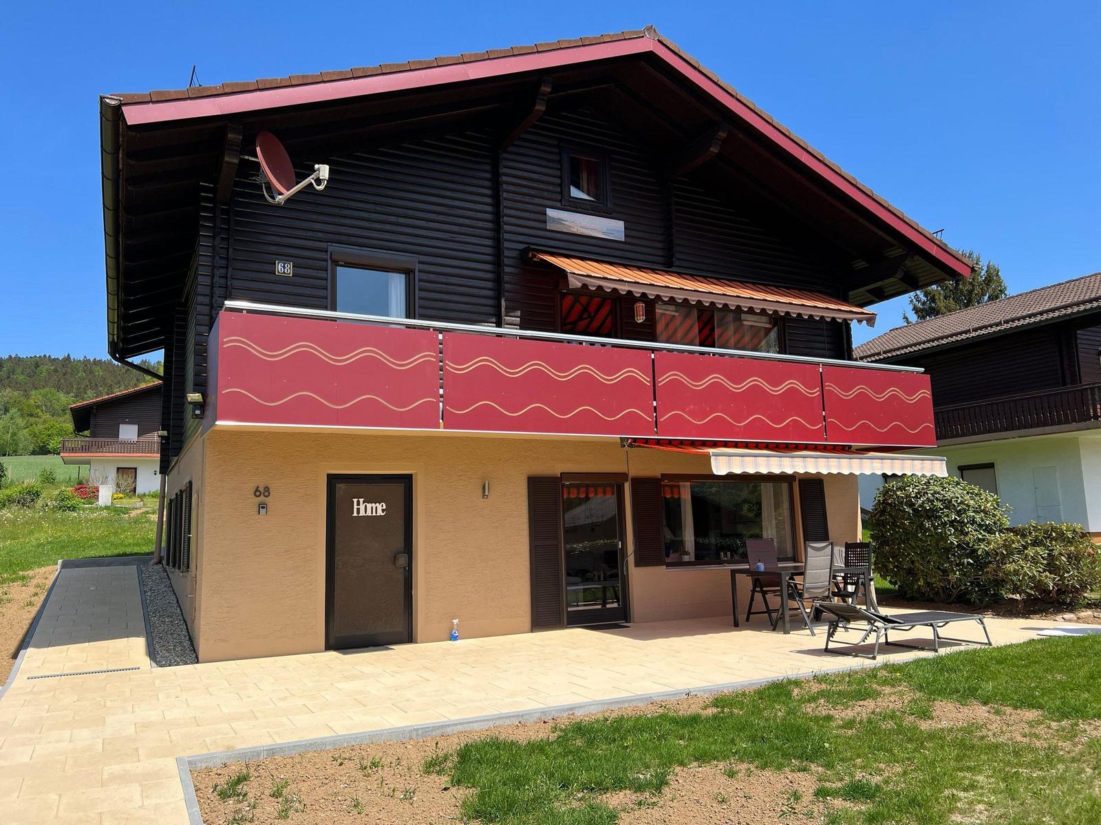 Two-story house with balcony, terrace, and garden. House number 68.