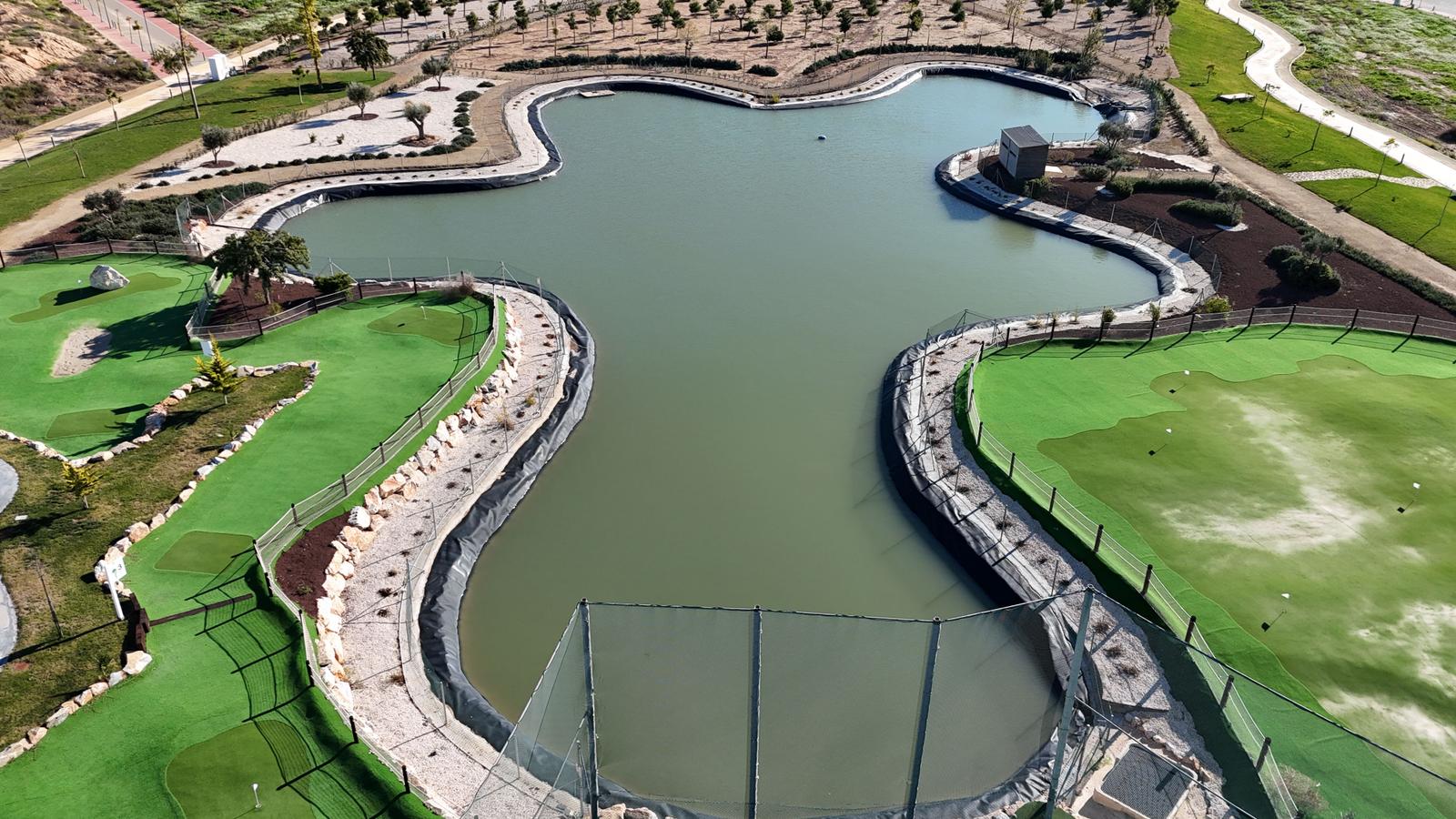 Aerial view of a mini golf course with a large water feature.