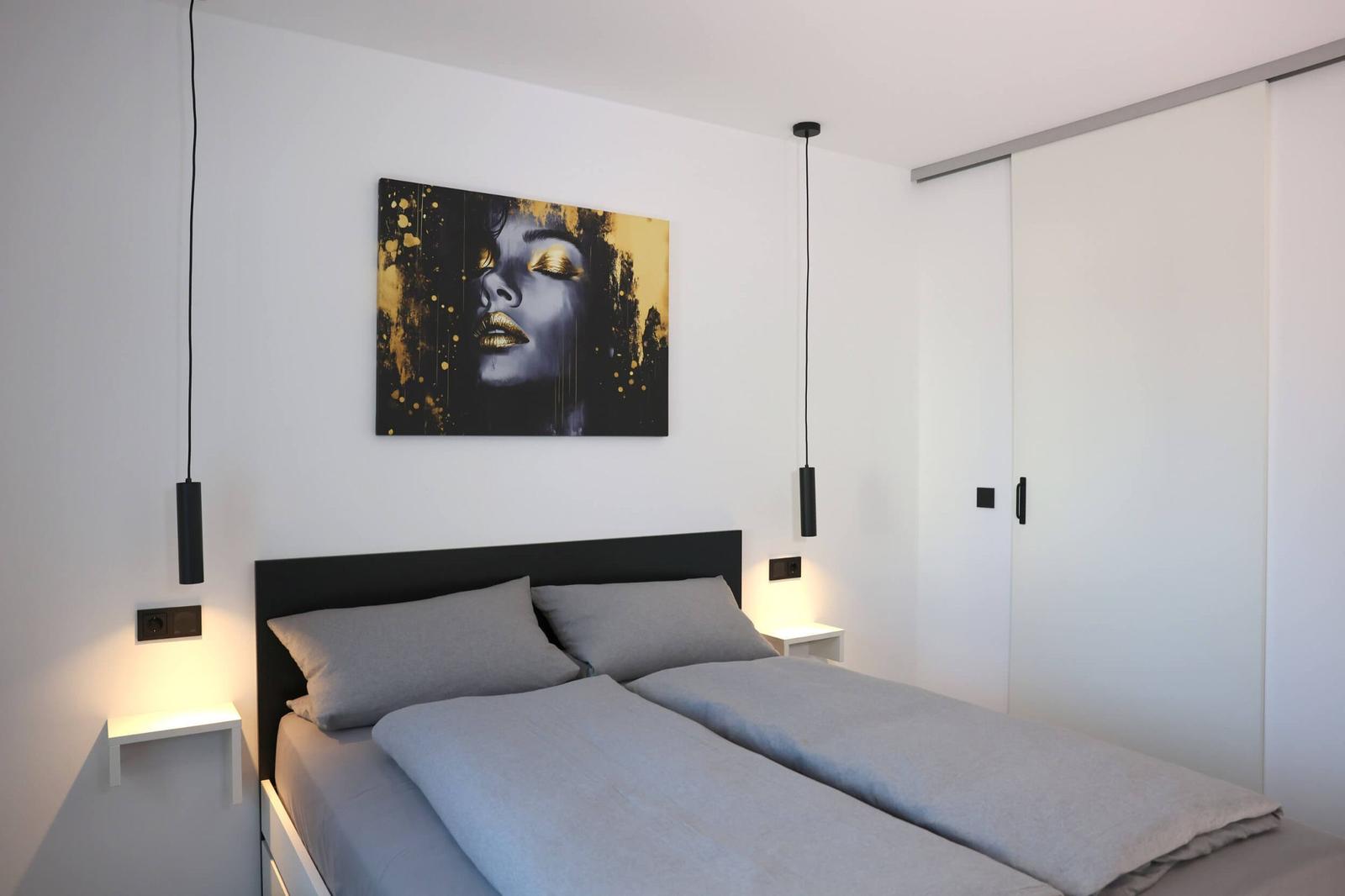 Comfortable double bed and sliding door to the living area