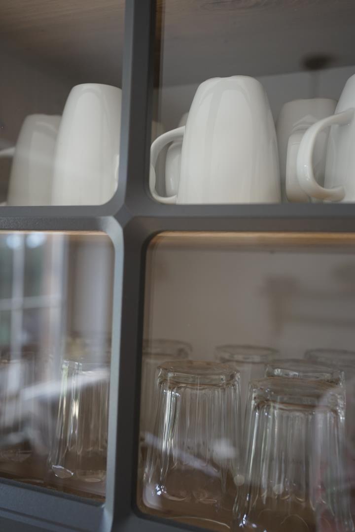 Glass and cup cabinet in kitchen area with good lighting