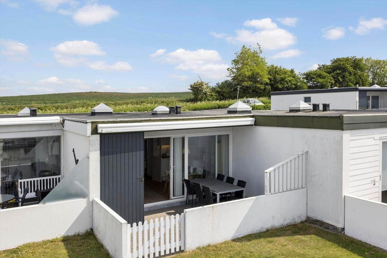 Moderne Ferienwohnung mit Terrasse und Blick auf grüne Landschaft.