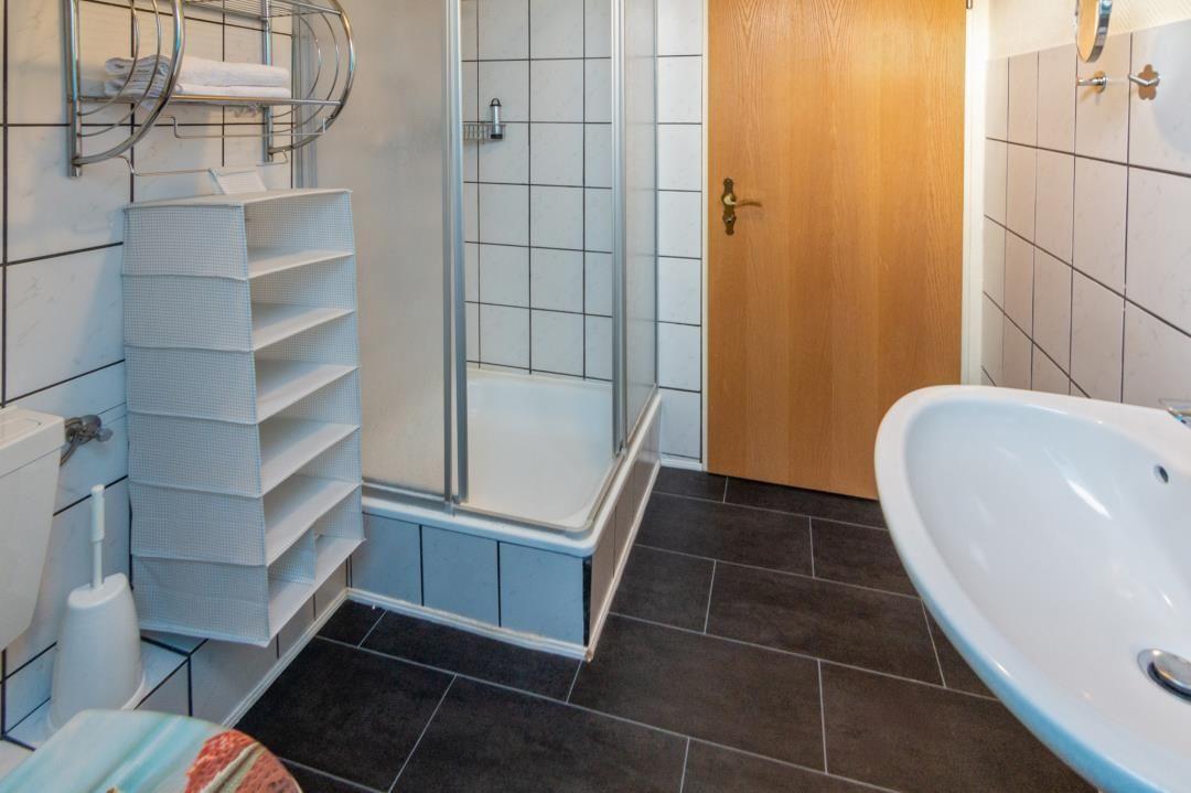 Bathroom with shower, sink, and toilet.