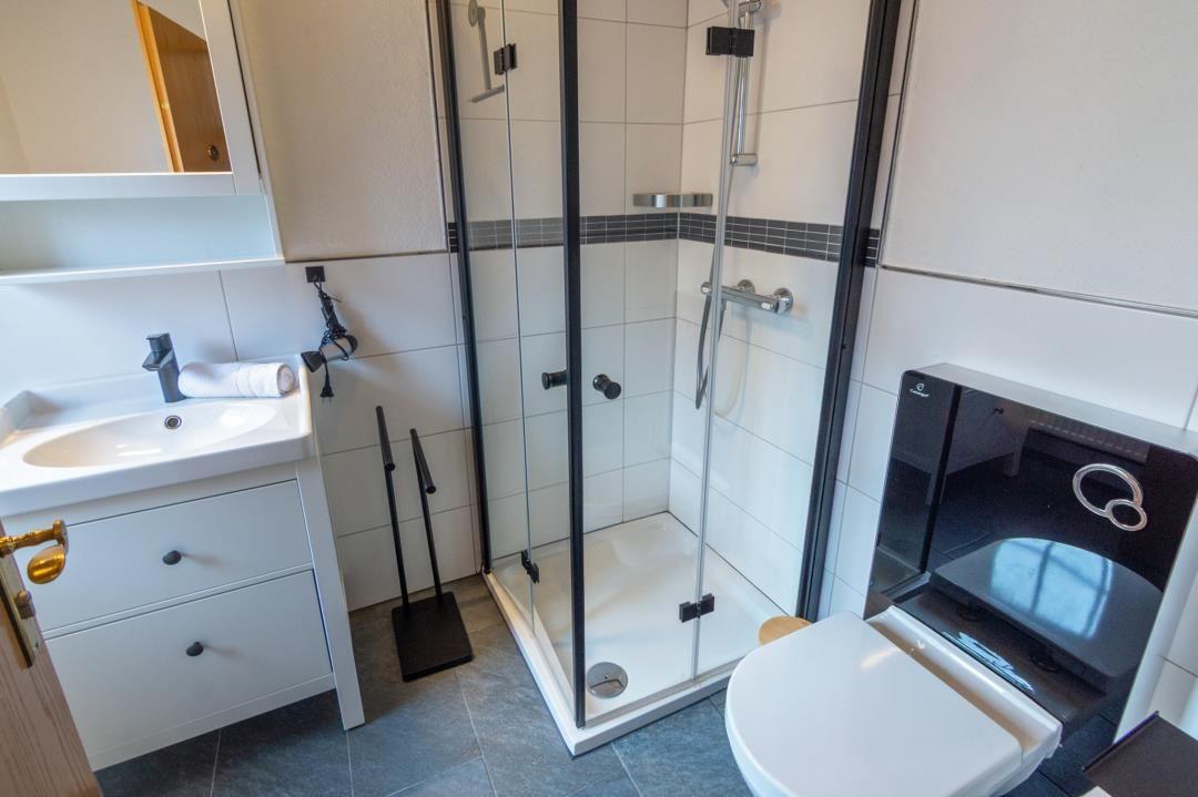 Bathroom with shower, sink, and toilet.