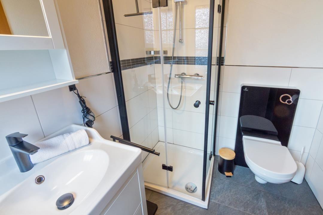 Bathroom with shower, sink, and toilet