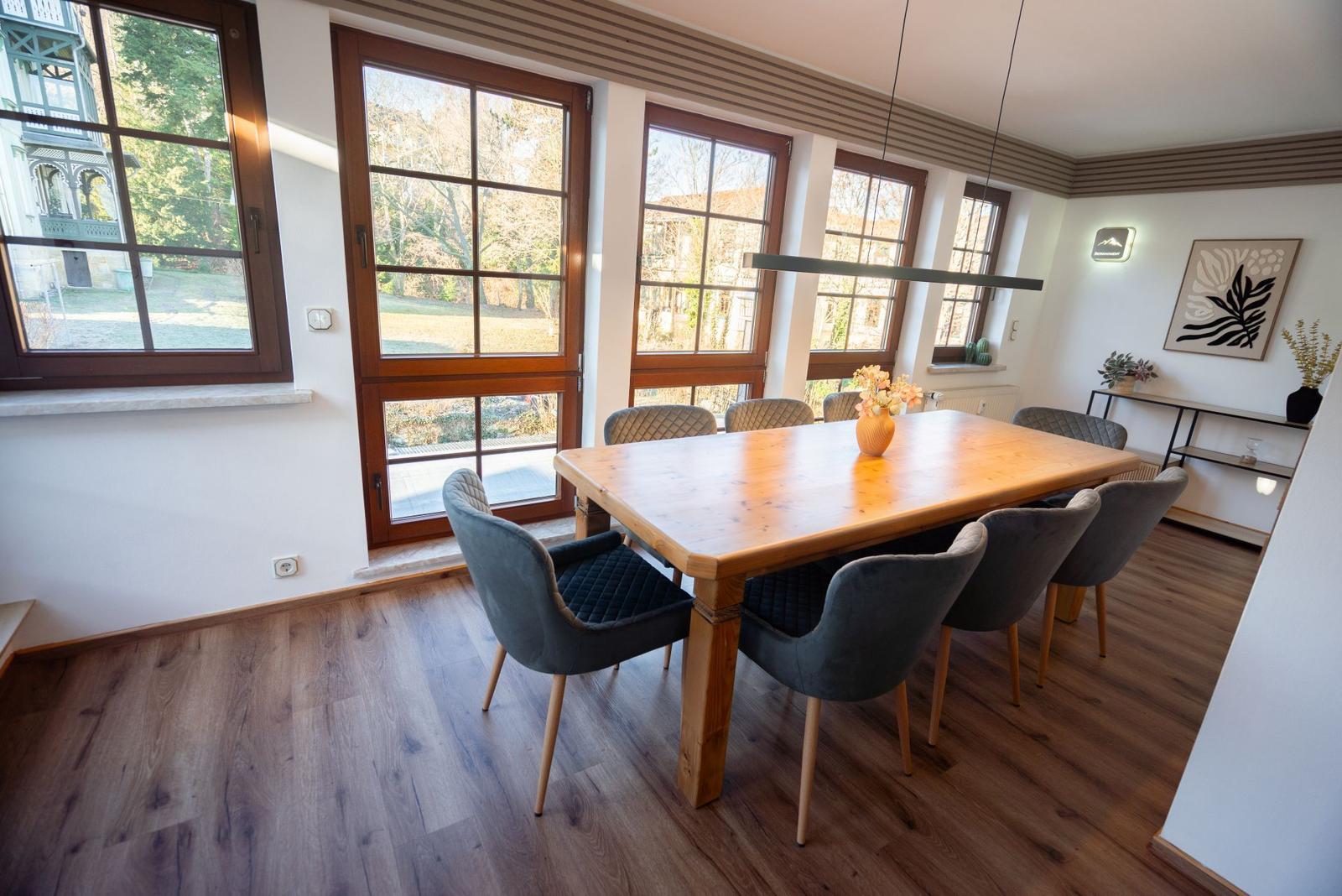 Heller Essbereich im Wintergarten der Ferienwohnung Bergmoment in Blankenburg Harz mit grossem Tisch fuer 8 Personen.