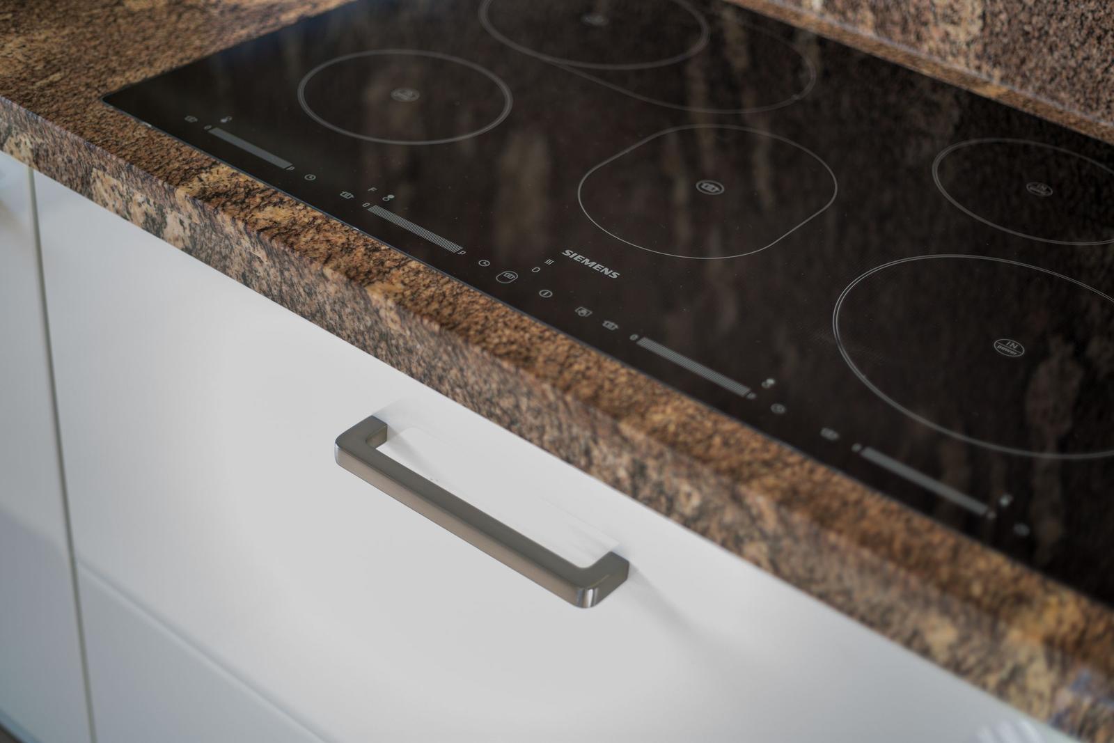 Küchenarbeitsplatte mit Induktionskochfeld und Schublade.