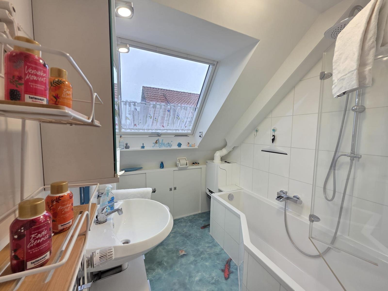 Bathroom with shower, bathtub, and skylight. Floor has fish pattern.