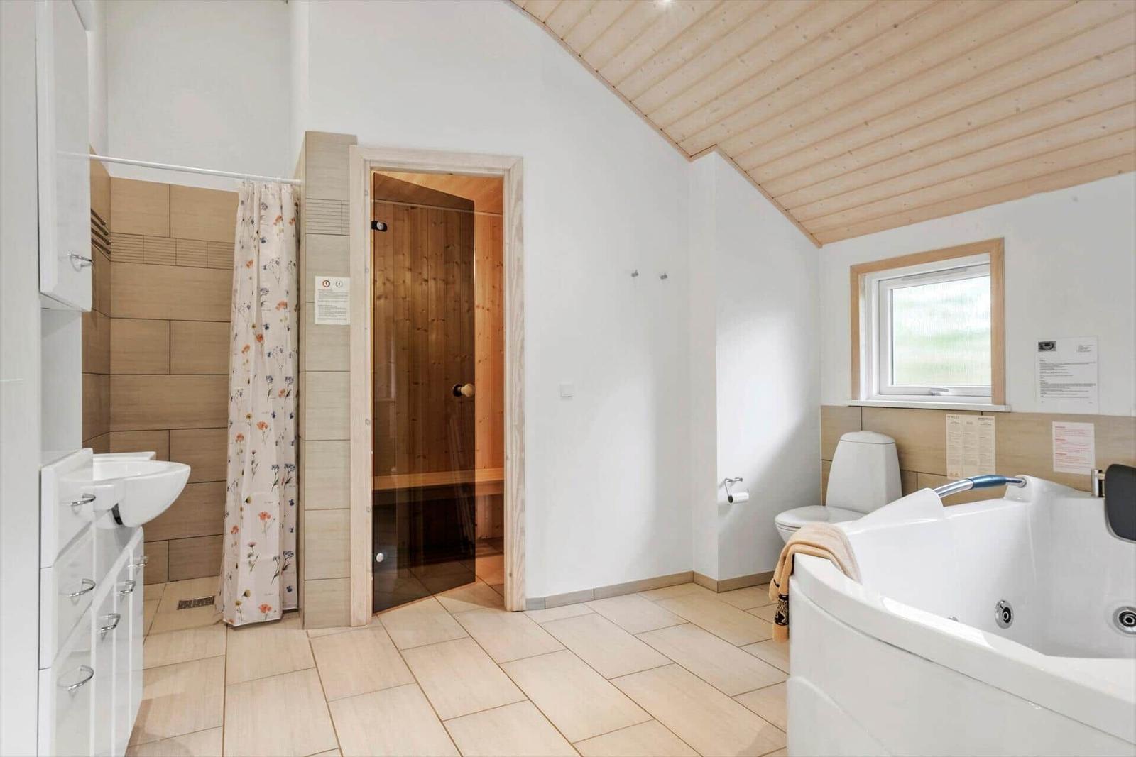 Bathroom with whirlpool, sauna, and shower