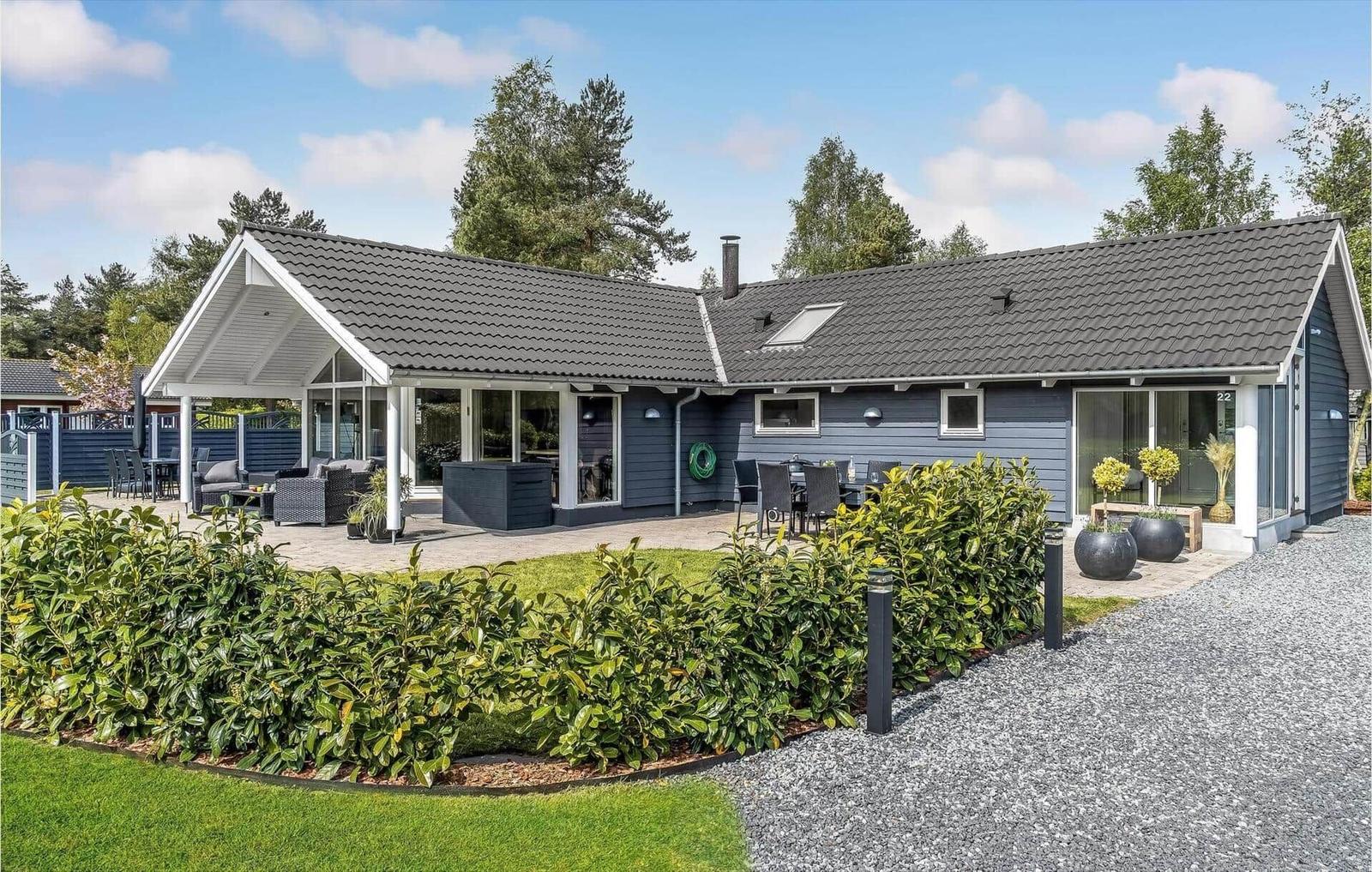 A modern house with terrace, garden and barbecue area. Backyard with seating areas.