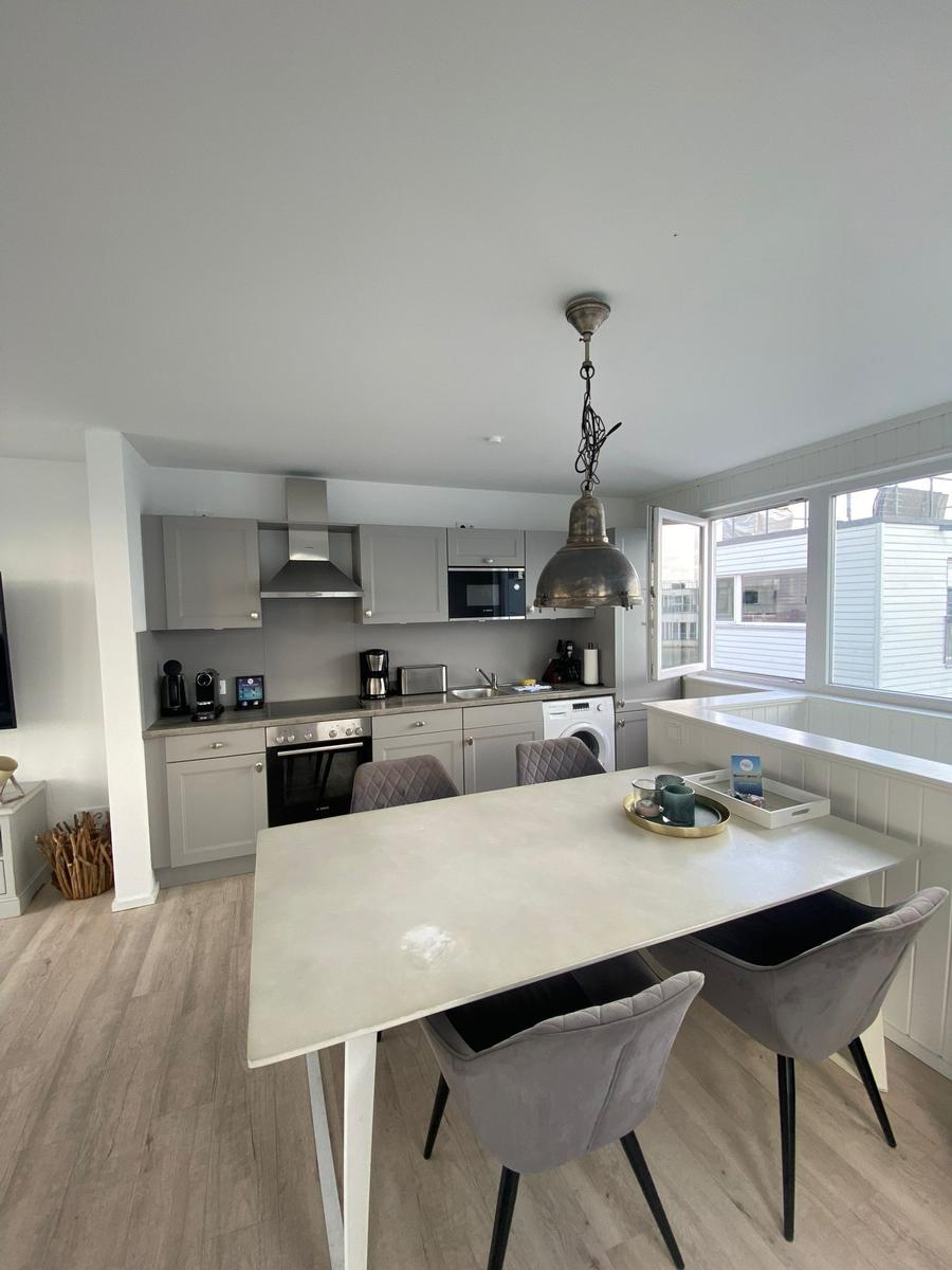 Kitchen with dining area, modern built-in kitchen, and large window