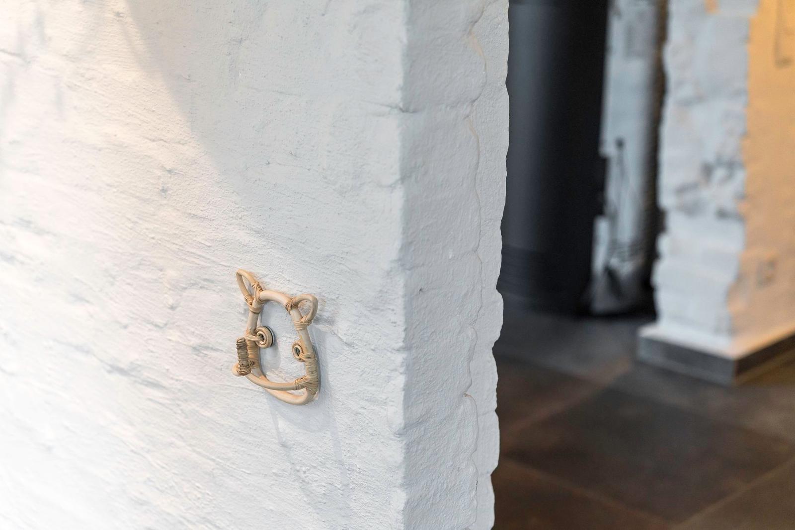 Wand mit Rattan-Handgriff und weißer Putzoberfläche