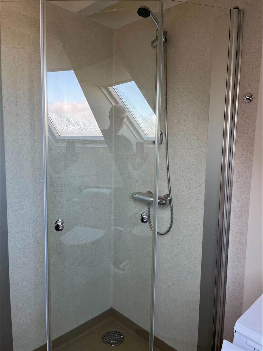 Shower enclosure with showerhead and skylight