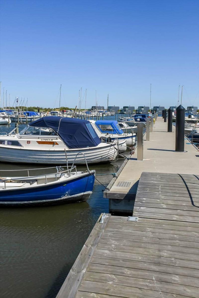 Marina with boats and dock under clear sky.