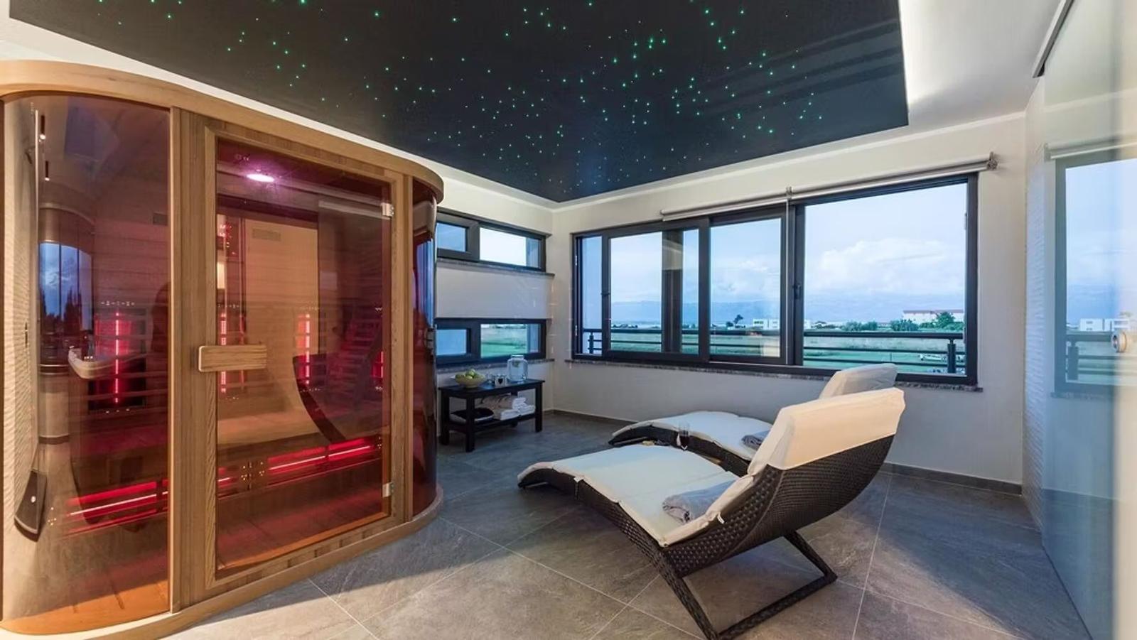 Sauna with star ceiling and loungers with view of landscape