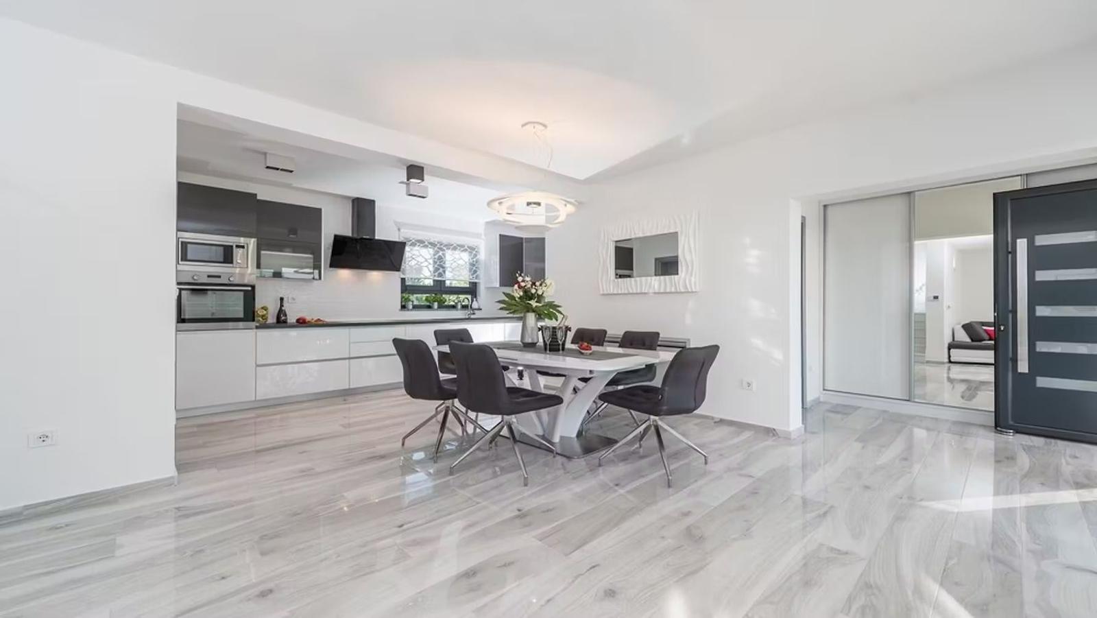 Modern kitchen with dining area and shiny floor
