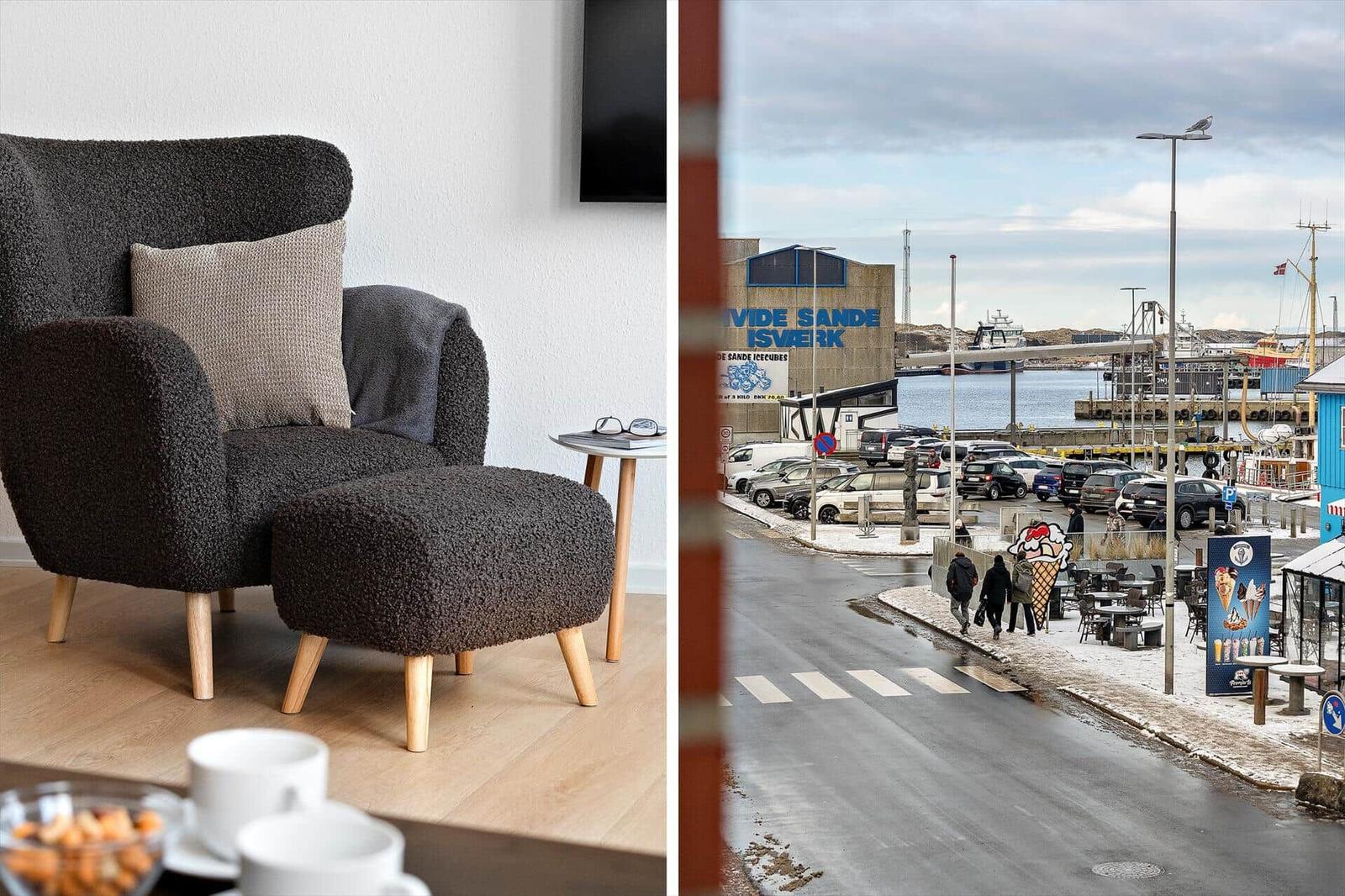 Schwarzer Sessel mit Kissen und Beistelltisch. Blick auf Hafen mit Eiscreme und Schiffen.