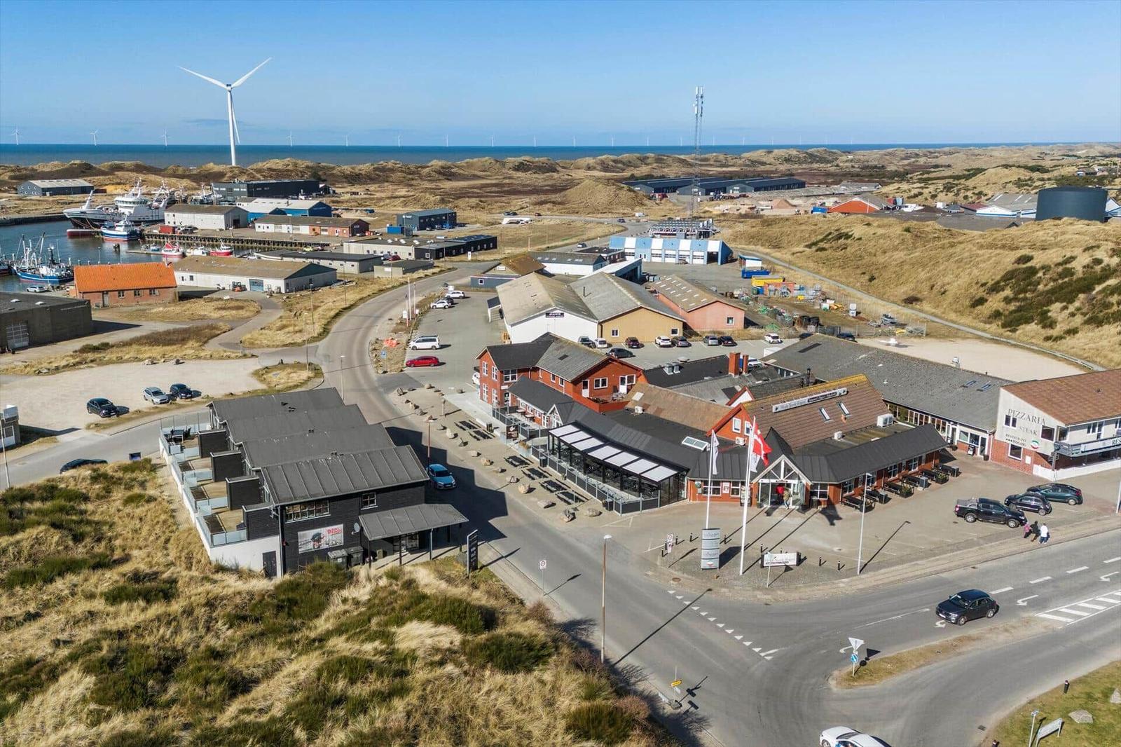 Aerielansicht von Häusern, Häfen und Windrädern an der Küste