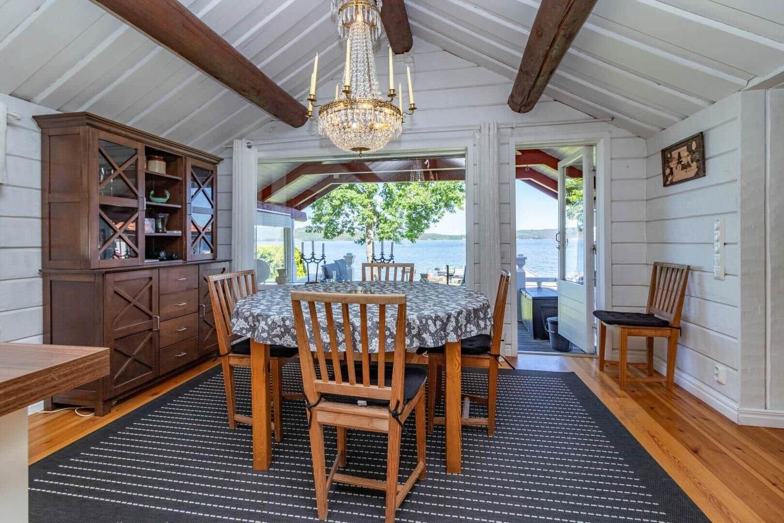 Esszimmer mit Tisch, Stühlen und Blick auf Wasser
