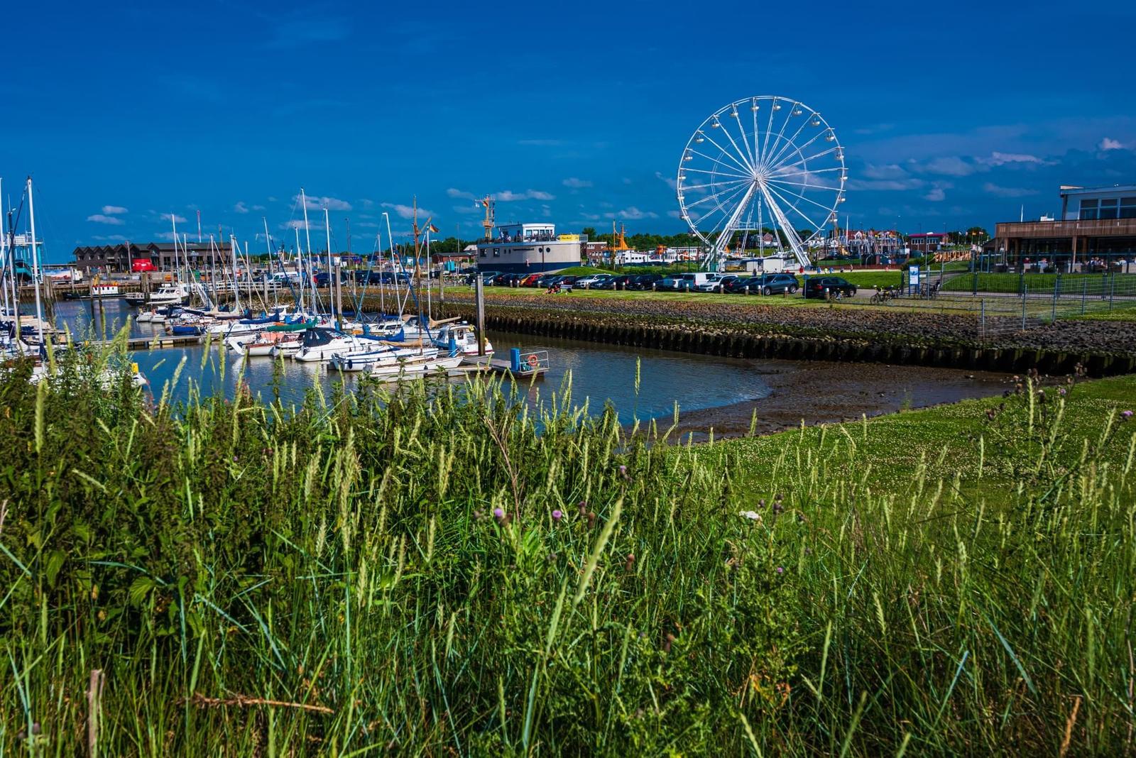 Hafen mit Booten und Riesenrad im Hintergrund
