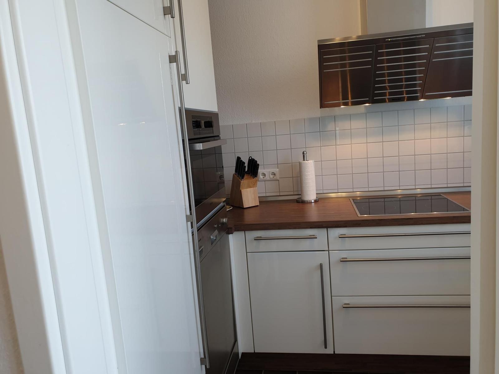 Kitchen with white countertop and stainless steel appliances.
