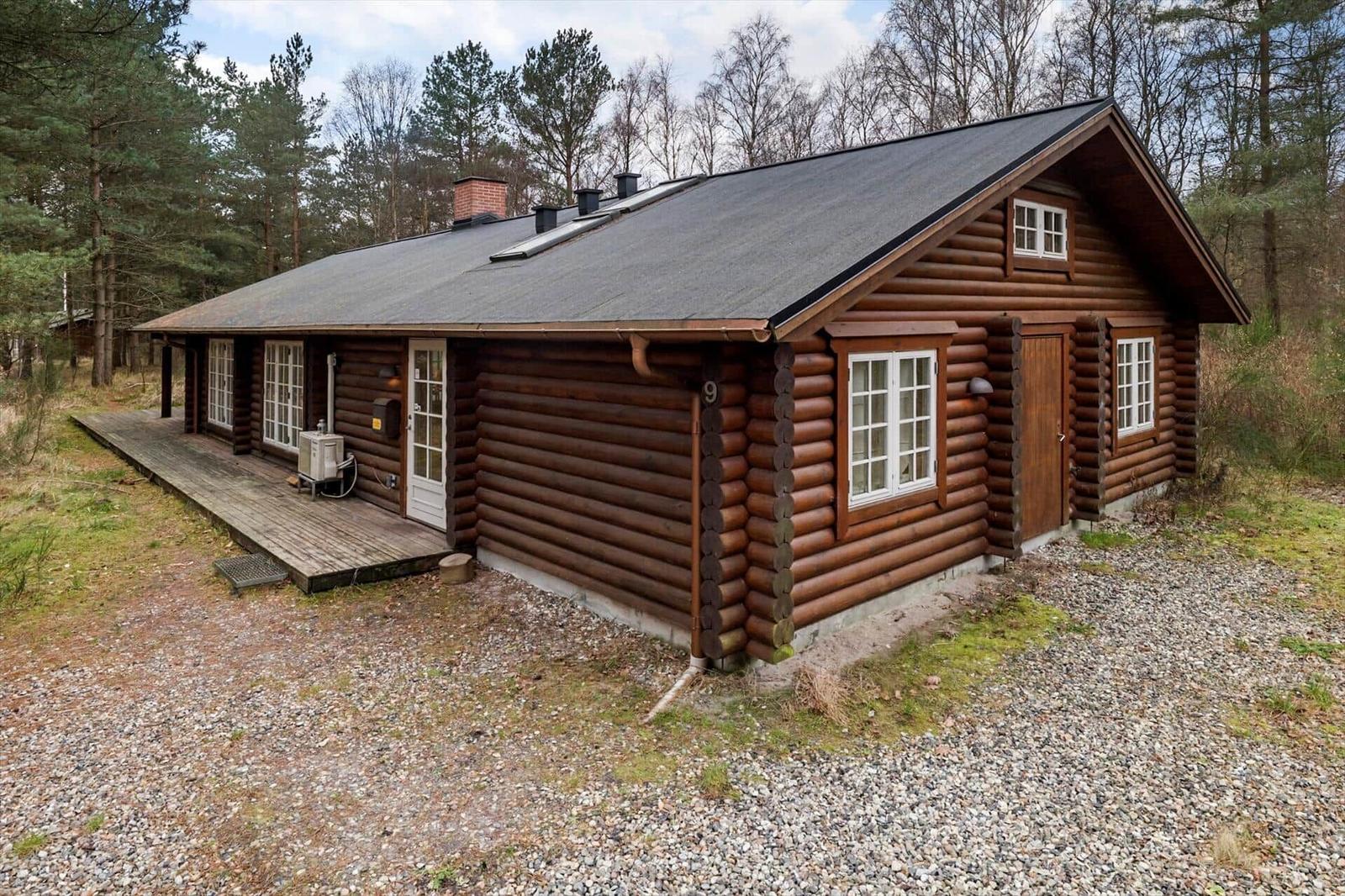 Holzhütte mit Veranda und Fenstern im Wald