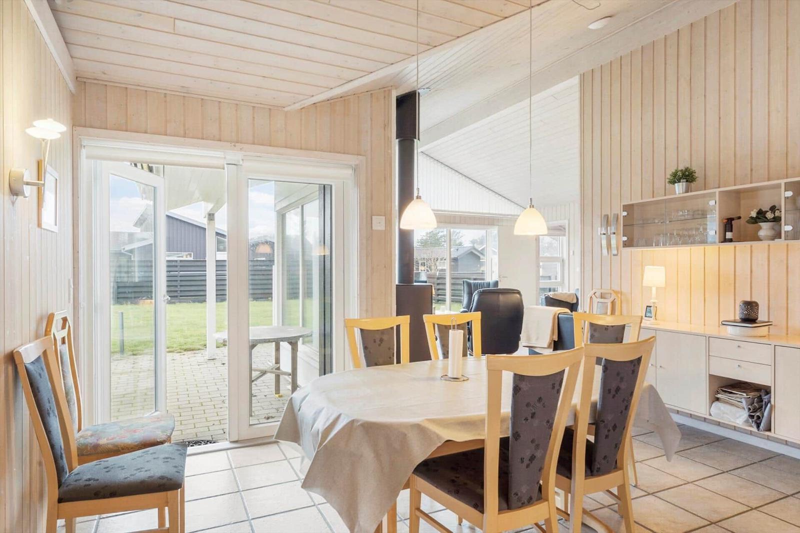 Dining room with table, chairs, and glass door to garden