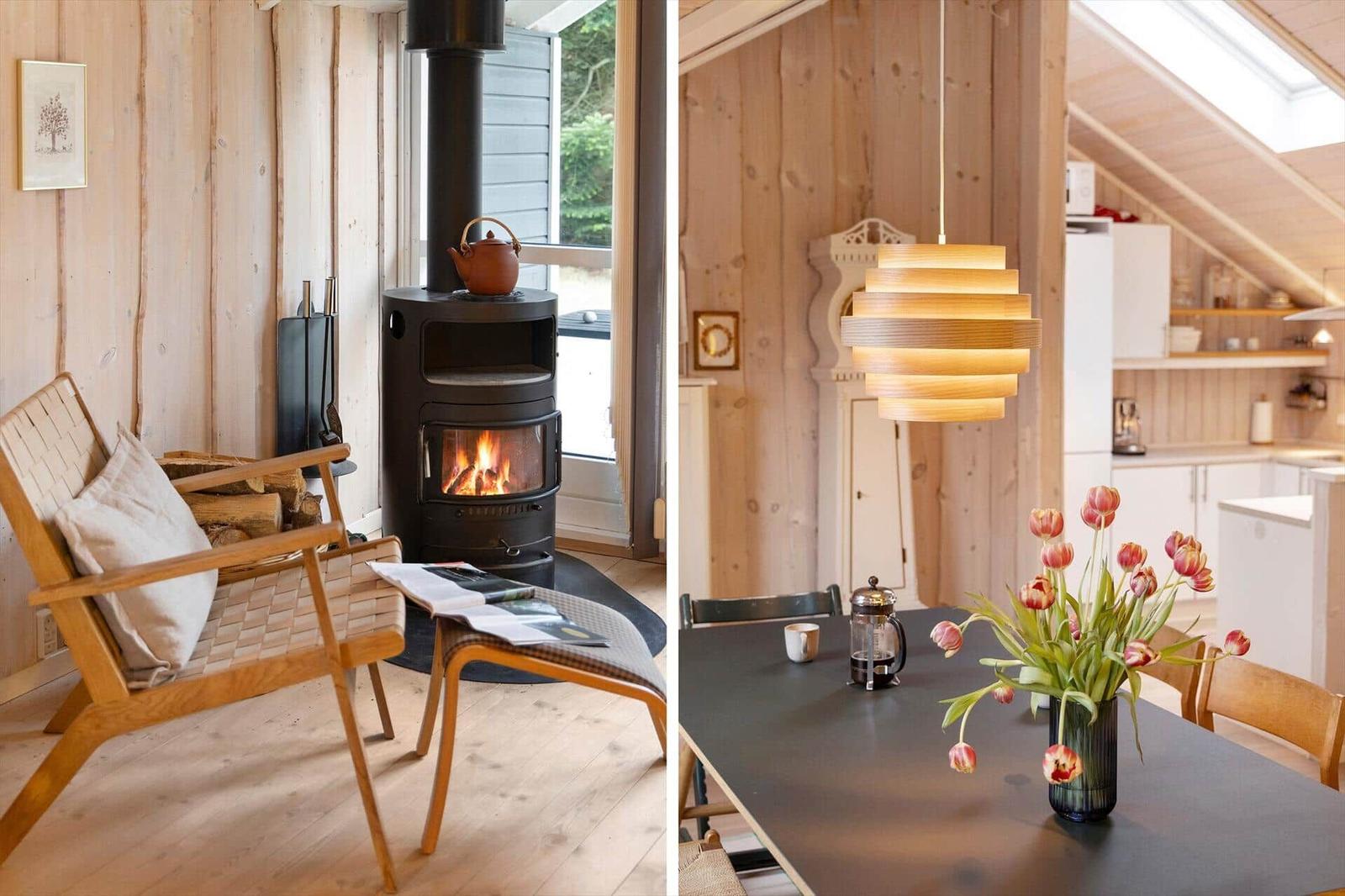 Living room with fireplace and dining area with table and flowers.