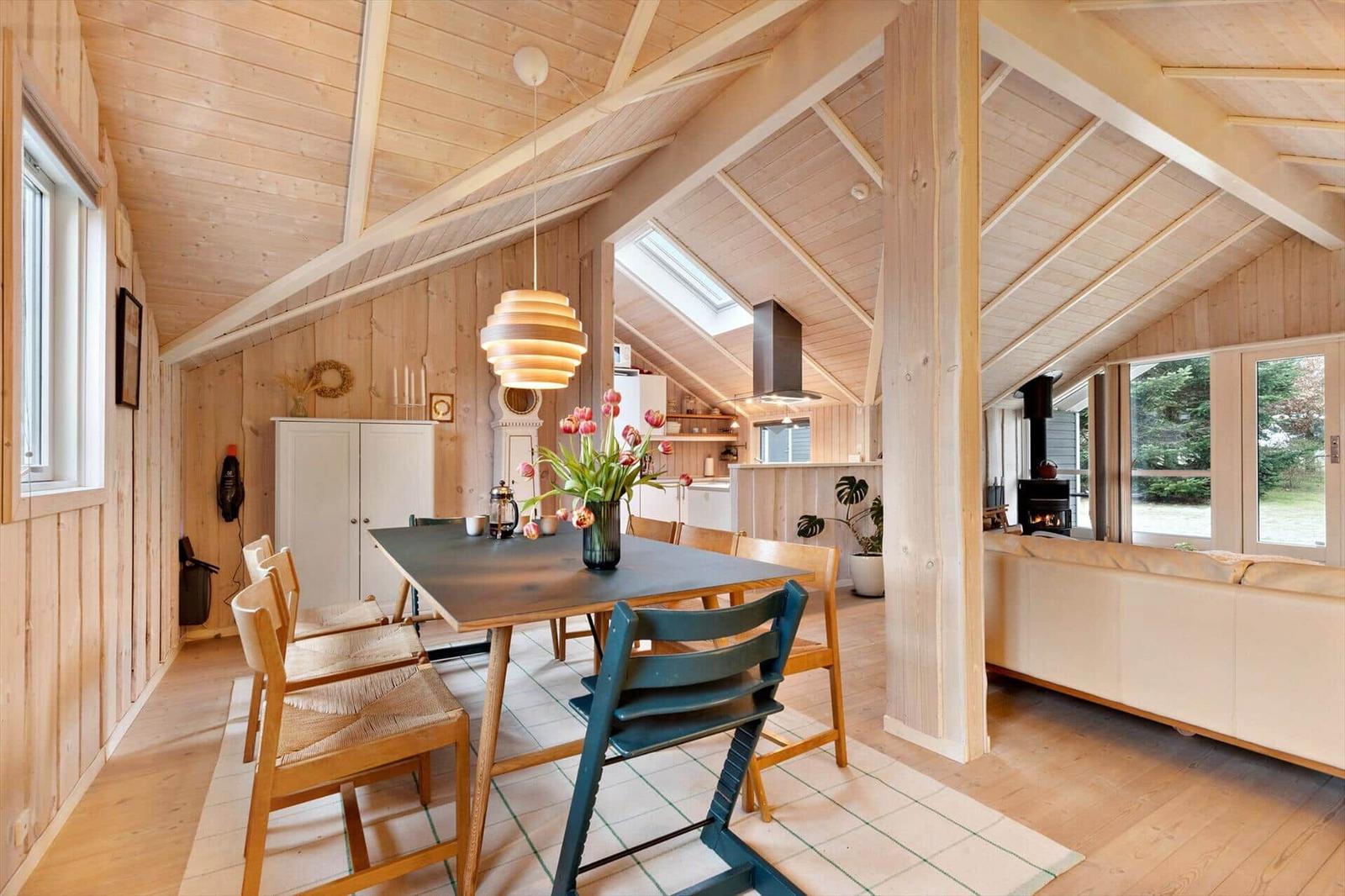 Dining area with table, chairs, and view into kitchen and living room