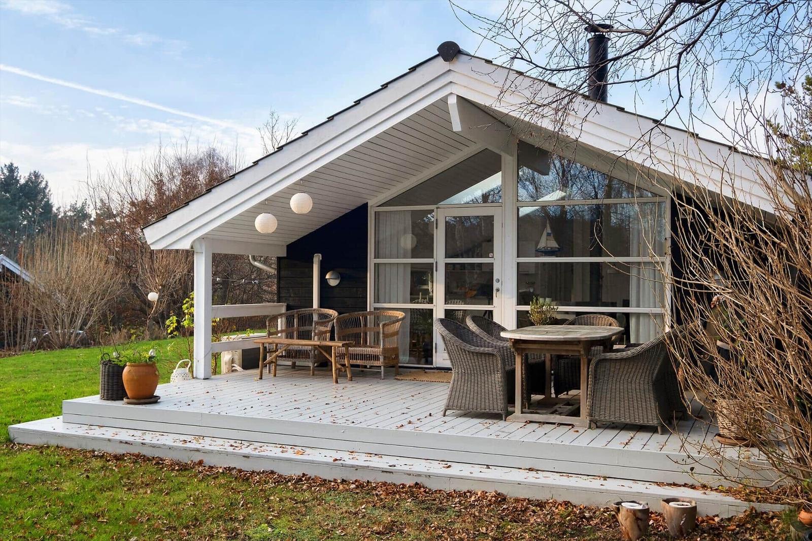 House with terrace, garden, and seating areas.