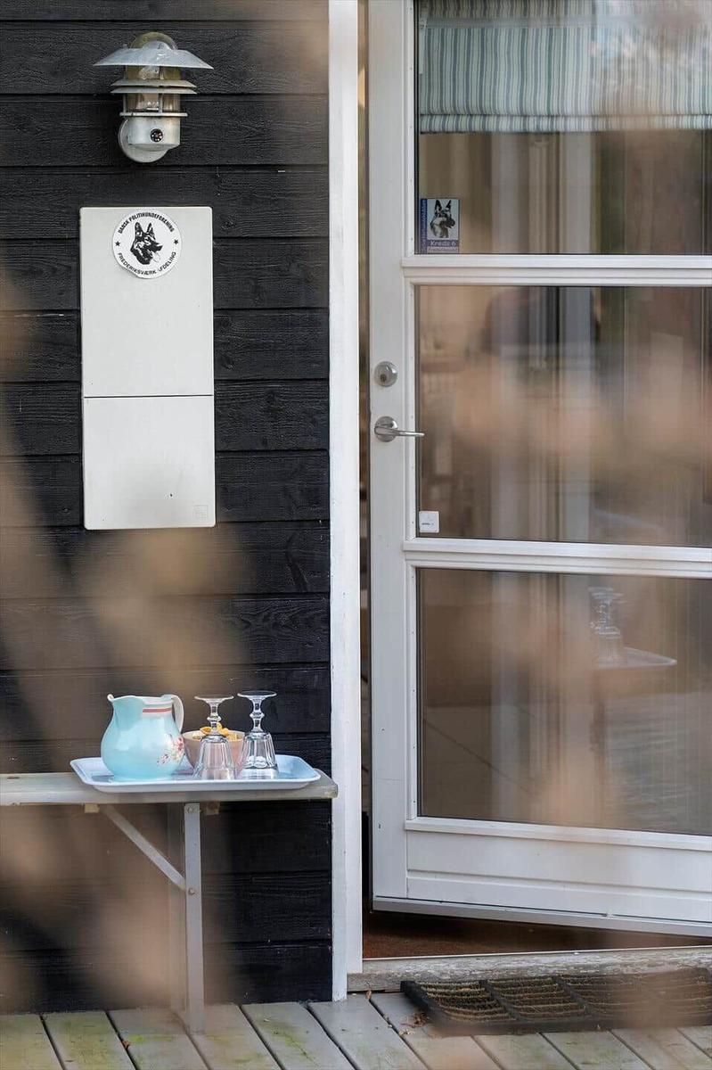 Bright door with glass panels and small table with cups and water glass.