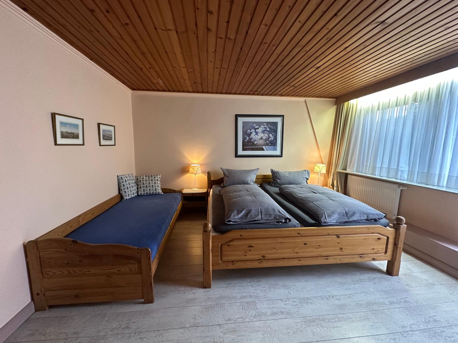 Großes Schlafzimmer mit Beistellbett.