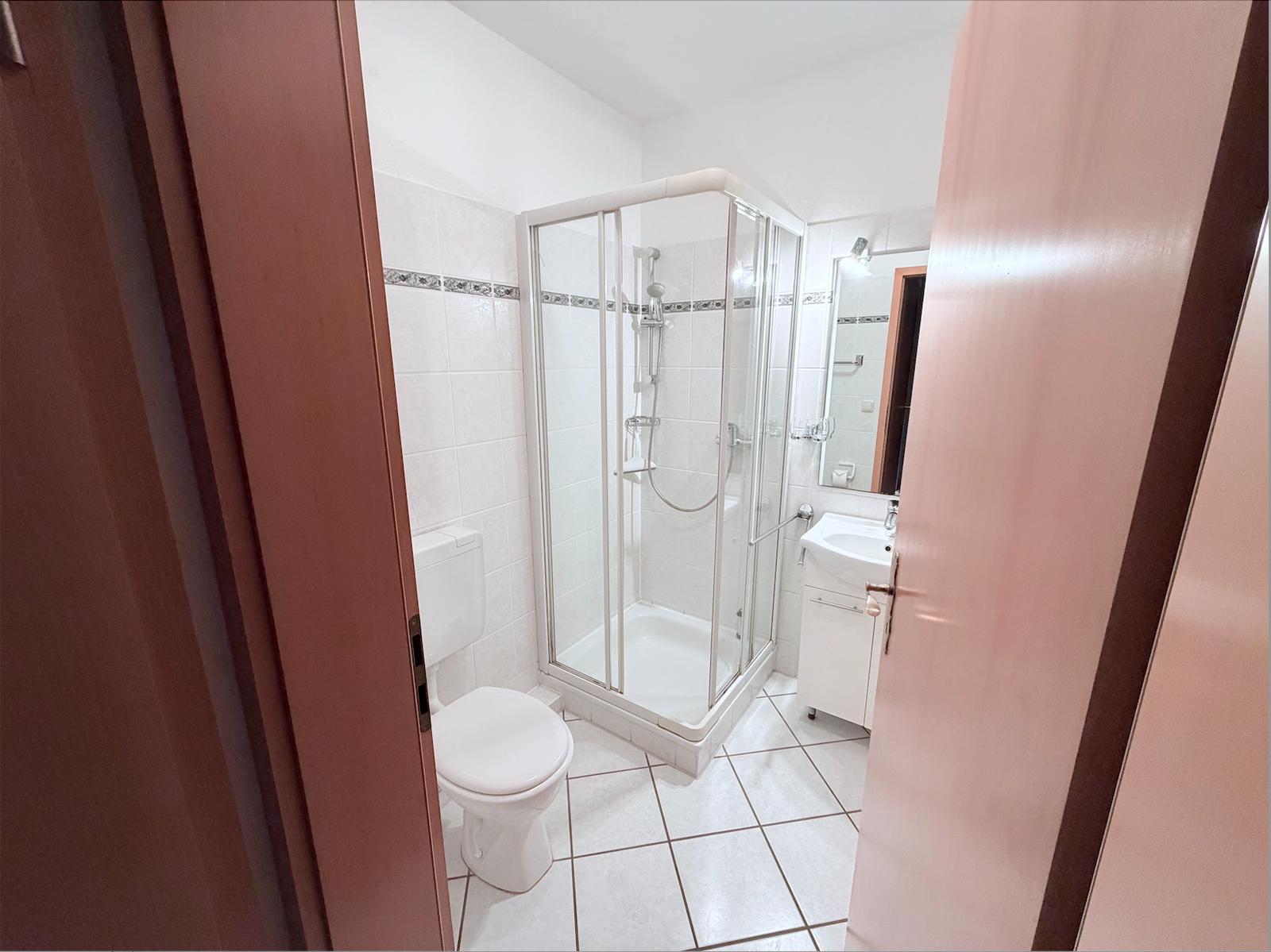 Bathroom with shower, toilet, and sink