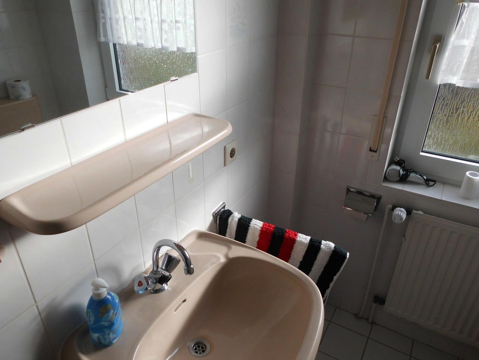 Bathroom with sink, mirror and window