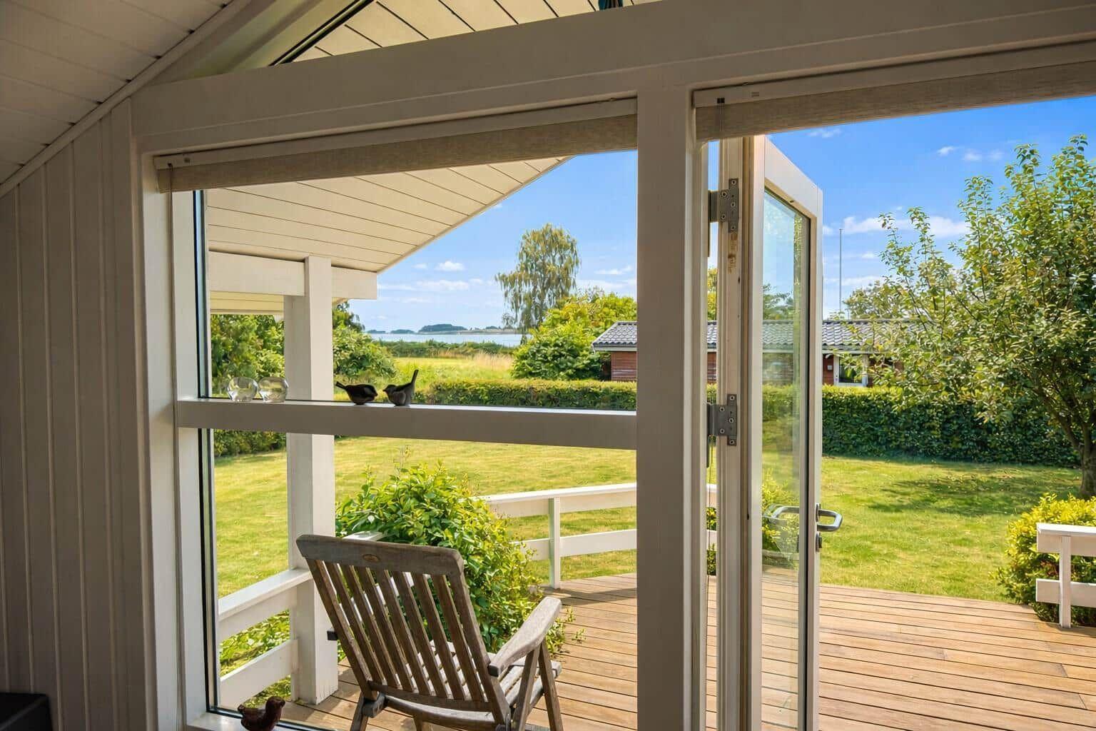 Through the glass door, the view opens to the terrace and garden.