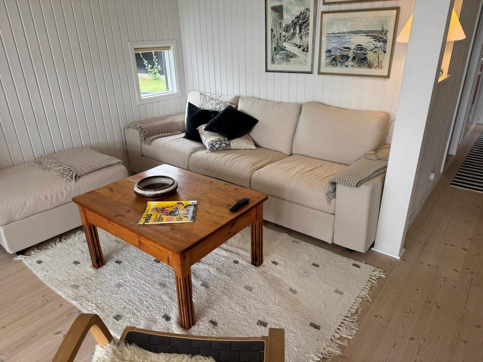 Living room with sofa, wooden table, and wall art.